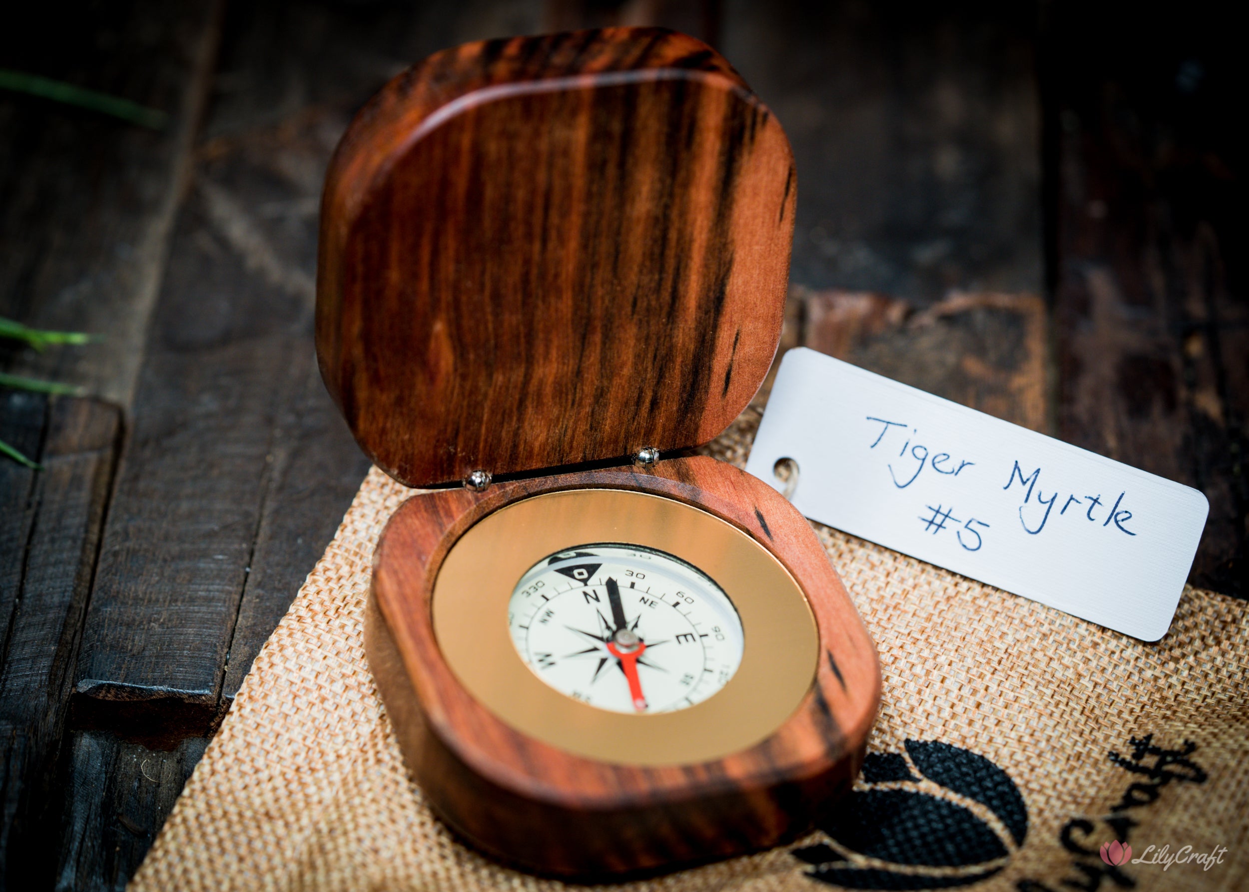 Engraved wooden compass in a rustic presentation.