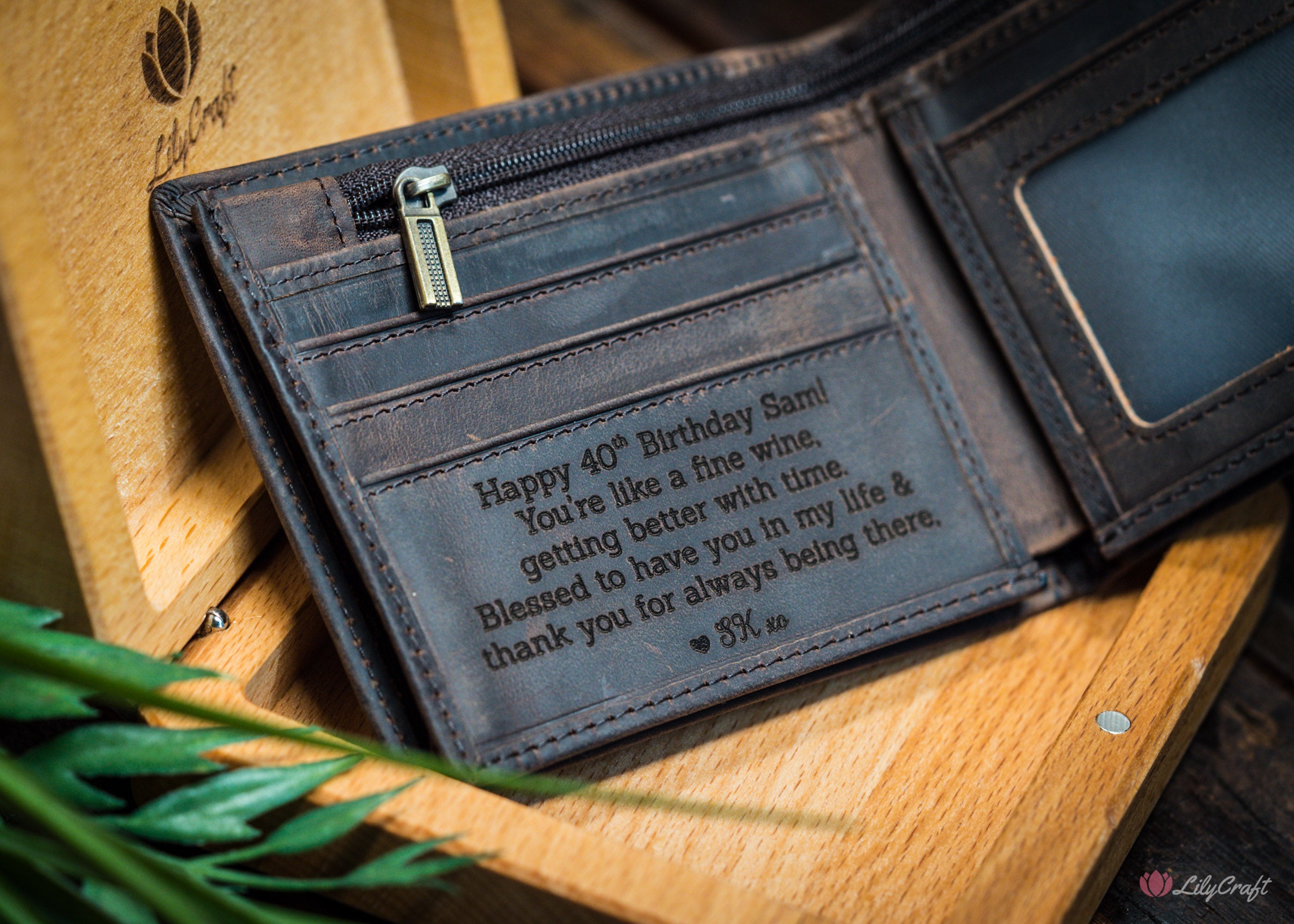 Brown leather wallet with engraved birthday message in a wooden gift box