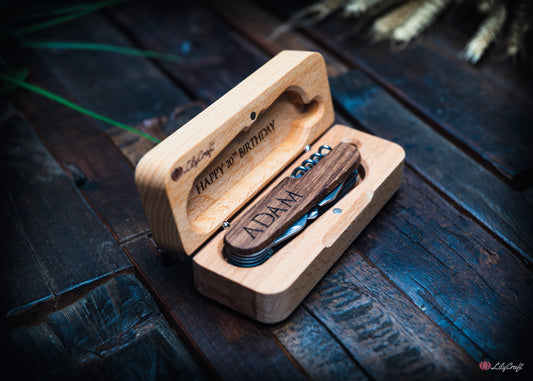 Wooden multi-tool with engraved text in a wooden gift box