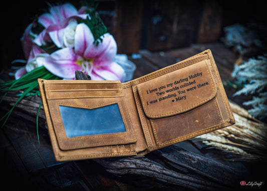 Vintage tan cowhide men’s leather wallet opened to show engraving on the coin pocket flap.