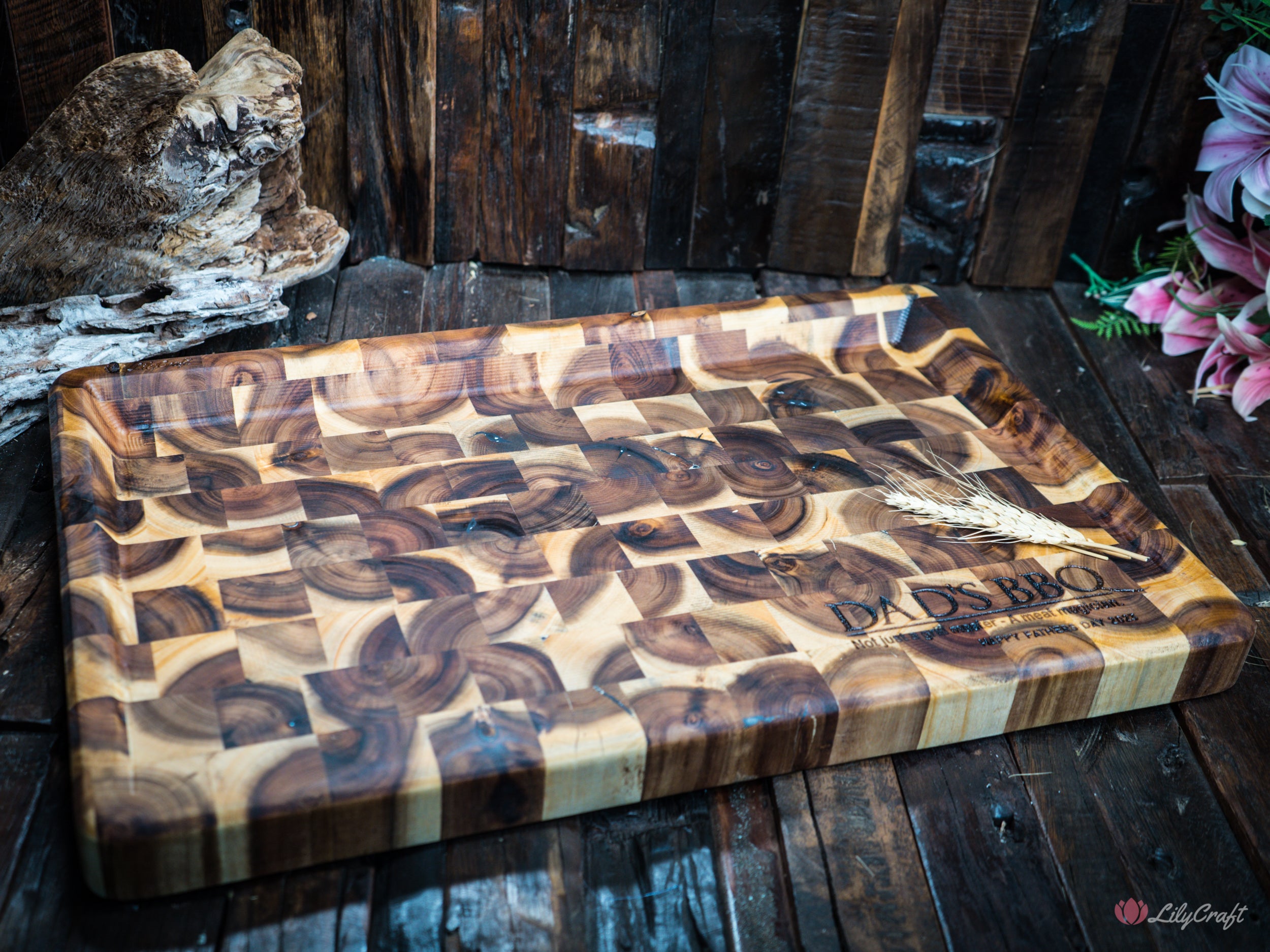 A personalized endgrain butcher's block BBQ cutting board with the owner's name engraved.
