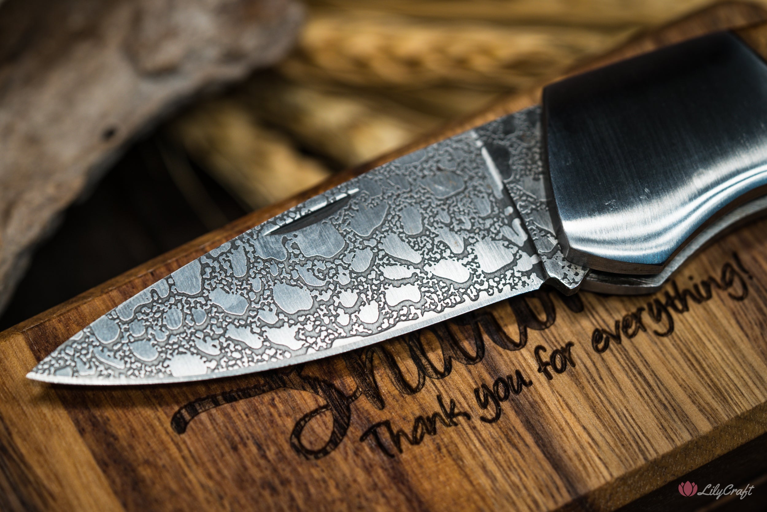 Close-up of sharp folding knife blade with intricate design