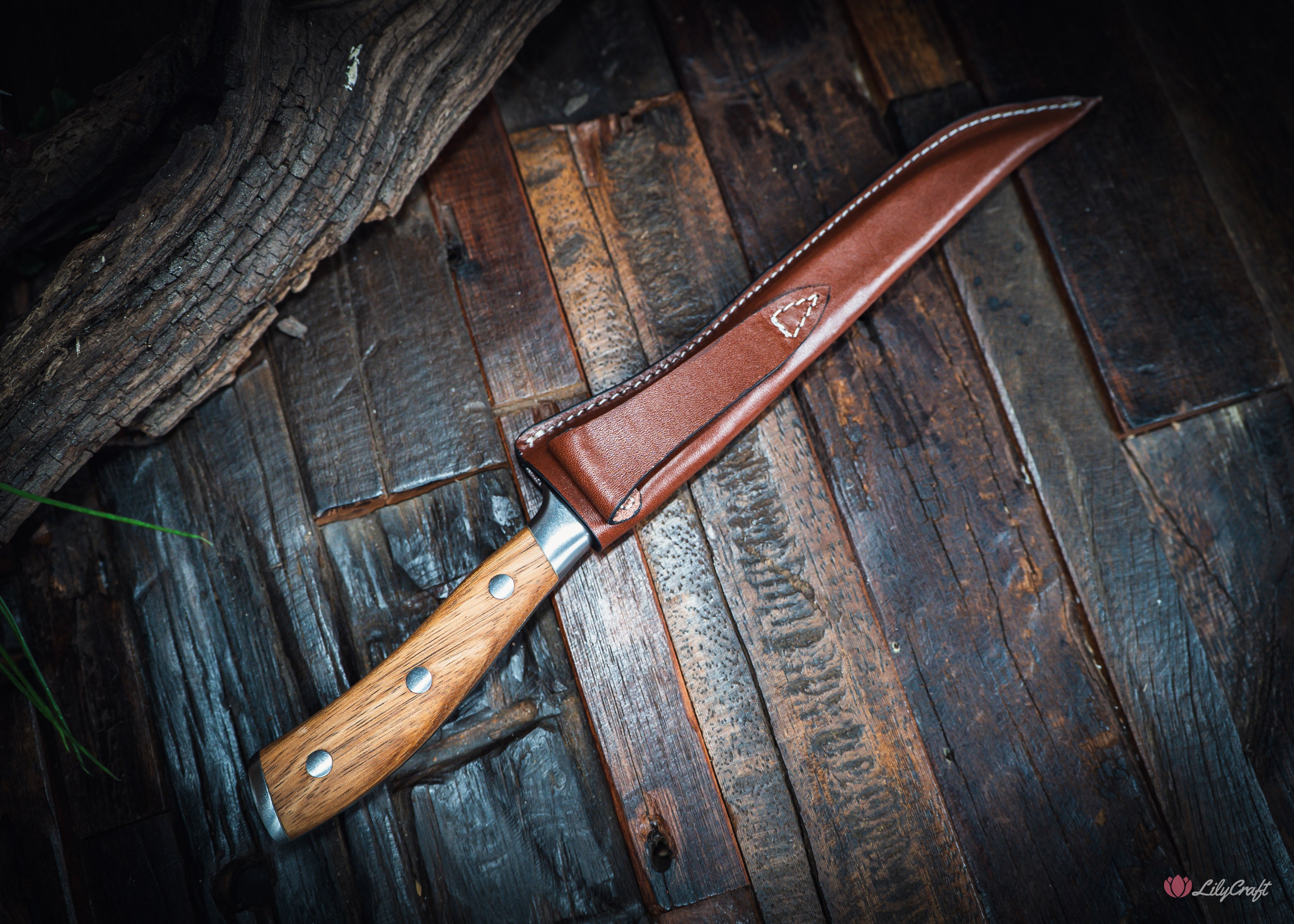 Handcrafted flexible zebra wood fish filleting knife on wooden cleaning board