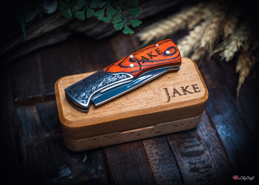 Engraved gentlemans pocket knife with timber handle folded beside beechwood gift box