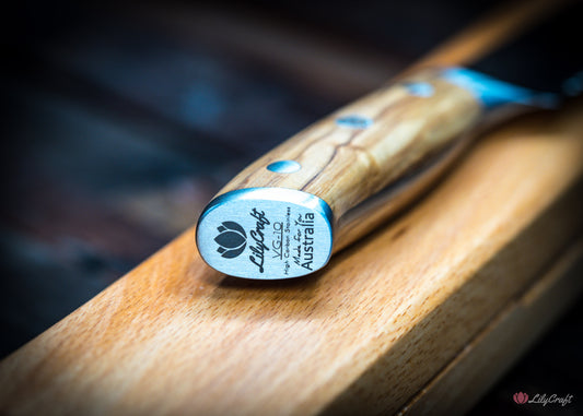 Rustic Damascus bread knife with natural olive wood handle