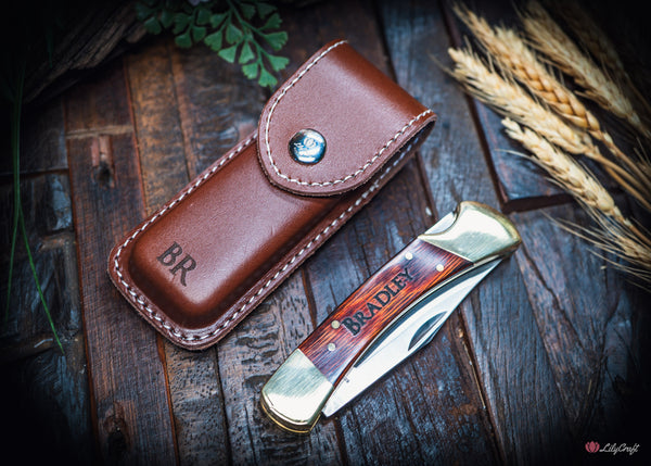 brass folding pocket knife with timber handle and leather sheath