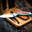 high end flip knife with rose wood inlay