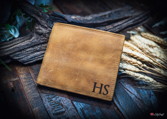 Engraved cowhide wallet showing initials on the front bottom corner and message inside.
