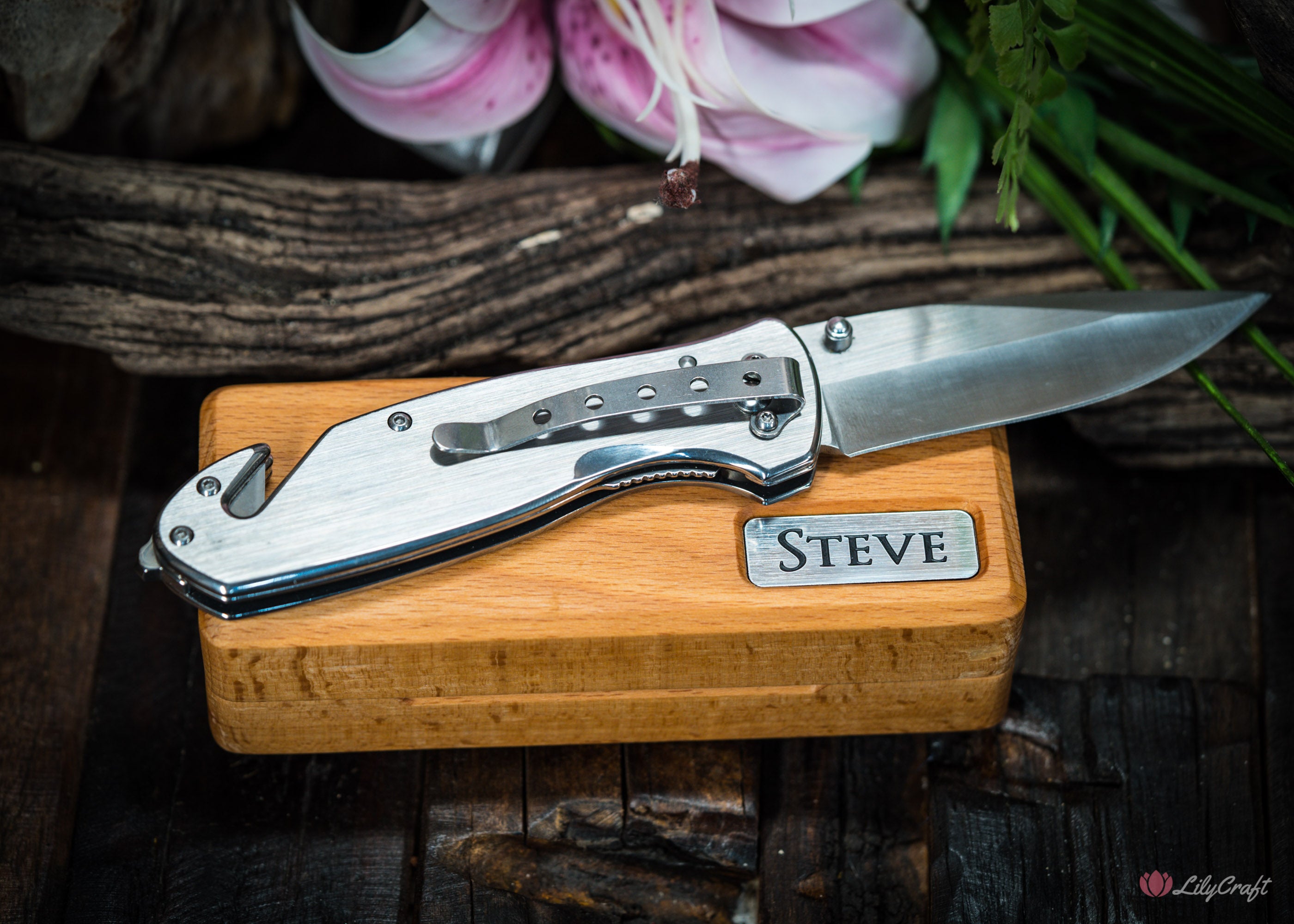 Folding survival knife with engraved handle and wooden case